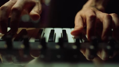 Musician Making Music in Dark Hall Man Hands Pressing Keys on Piano Indoor.