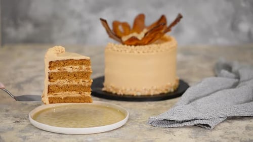 Slice of Delicious Caramel Cake Being Served