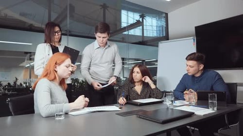 Business Team Collaborating on Data Analysis in Office