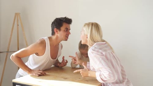 Couple Arguing as Young Child Looks On, Upset