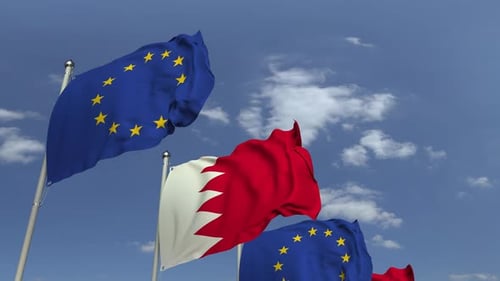 Waving Flags of European Union and Bahrain on Blue Sky