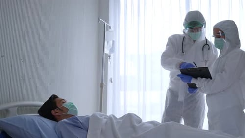 Medical Staff Reviewing Patient Chart in Hospital