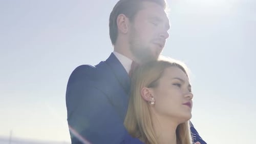Loving Couple Embracing on Sunny Beach Coast