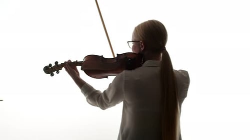 Blonde Woman Playing Violin in Studio