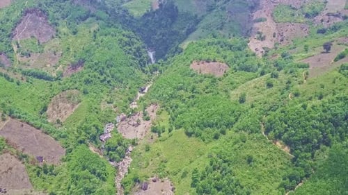 Panoramic View Distant Waterfall Among Hilly Lands with Plants