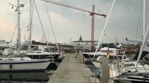 Tracking Shot Along the Harbour with Ships and Boats Docked By the Pier
