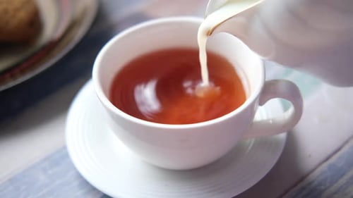 Close Up of Pouring Milk in a Tea Cup