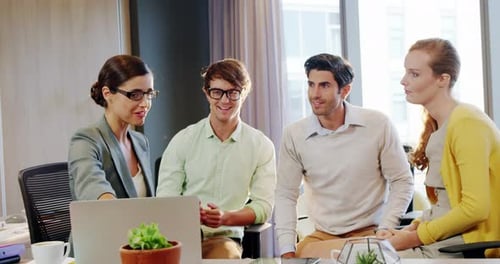 Team Discussing Project in Bright Modern Office