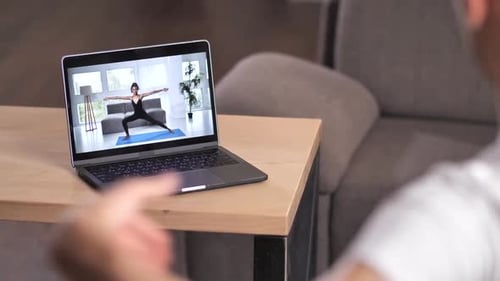 Woman on Laptop Doing Yoga