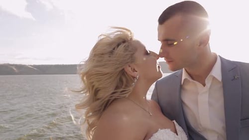Affectionate Couple Kissing on Wedding Day at Ocean
