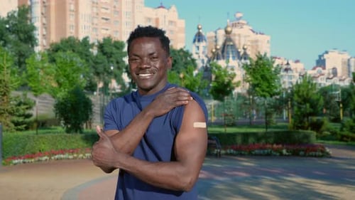 Man With Arm Bandage Giving Thumbs Up Outdoors