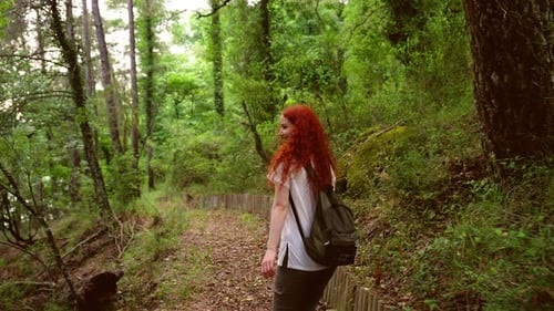 Smiling Woman Running Though Forest