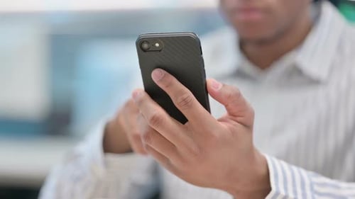 Close Up of African Businessman Using Smartphone