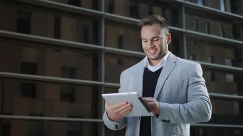 Businessman Browsing Internet on Digital Tablet in City. Manager Using Touchpad