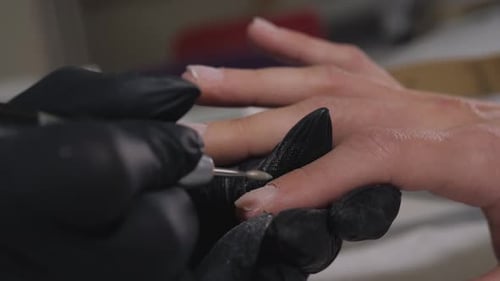Manicurist Files Nails in Salon Close Up
