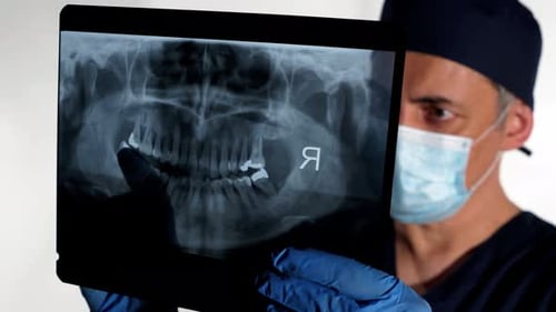 Doctor Examining Dental X-Ray in Hospital Setting