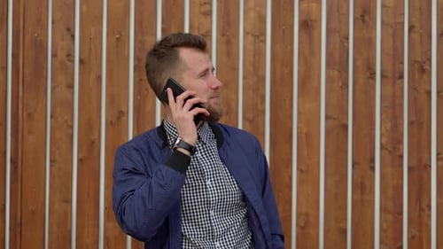 Adult Man Talking on Smartphone Outdoors