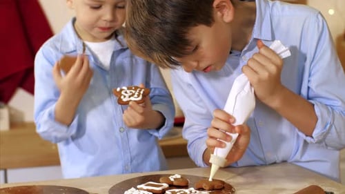 Boys Decorating Cookies for Christmas at Home