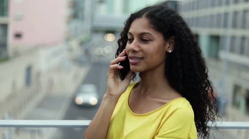 Young Woman Talking on Cell Phone in City