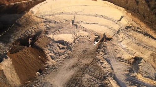 Aerial View of Open Pit Mining Site of Limestone Materials for Construction Industry with Excavators
