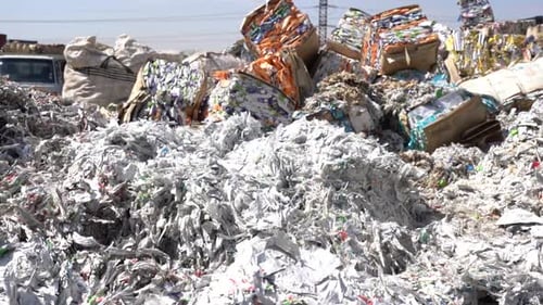 cinematic shot of shredded paper at a recycling plant