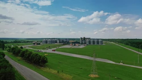 Grain elevators in meadow. Aerial view of agro elevator grain storage