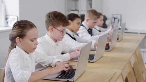 Caucasian Preteen Schoolchildren Using Laptops at E-Learning Class