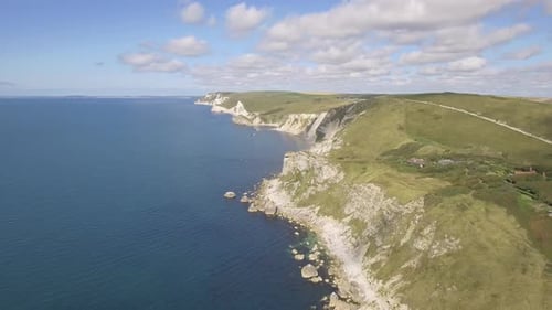 Cornwall aerial drone view of seaside rocky cliffs and turquoise water