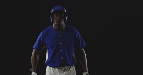 Intense Baseball Player with Bat in Dark Studio