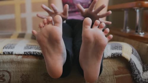 Child's Feet and Hands Close Up on Sofa