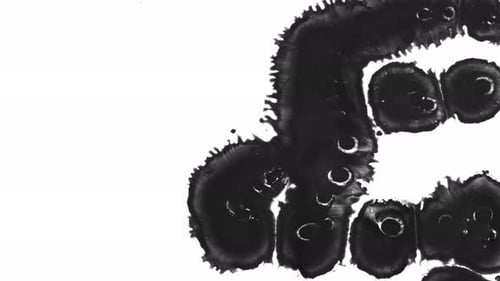 Black Ink Spreading on White Surface