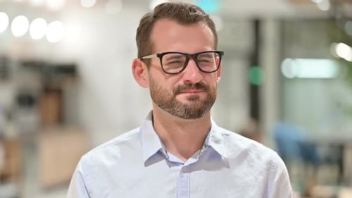 Man with Glasses Smiling at the Camera