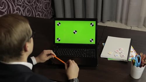 Man Teacher Making Online Video Call on Laptop. Green Screen. Distance Education