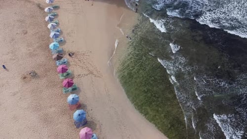 Aerial Top view of beautiful tropical beach, white sand beach and colorful umbrella