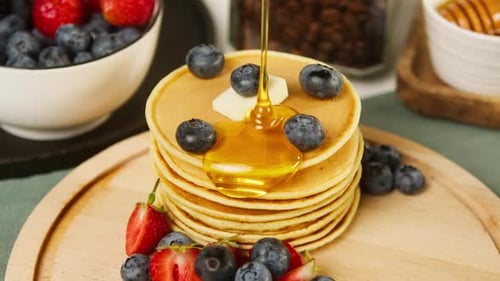 Pancakes with Berries and Syrup for Breakfast