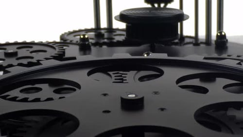Metallic Balls Rolling Around Black Mechanical Gear System