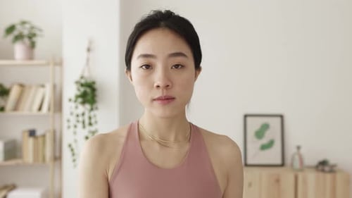 Young Woman Doing Arm Workout with Dumbbell