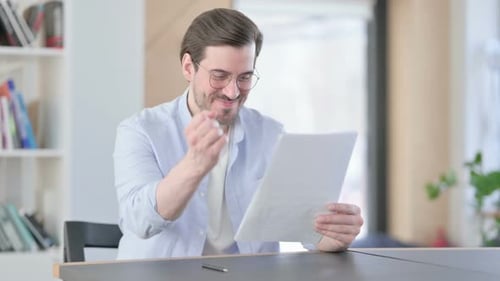 Man Receives Good News, Celebrates Reading Document