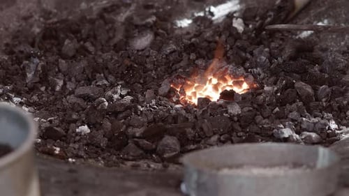 Metal Disc Heating in Hot Coals with Flames
