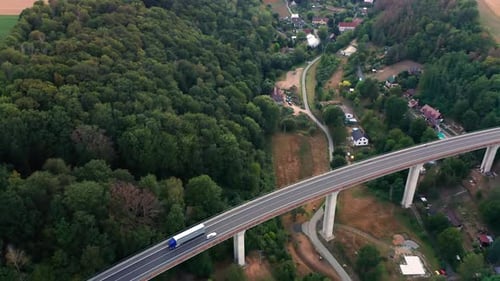 Aerial View of the Bridge with Moving Cars and Amazing Panoramic View of the Forest and Field