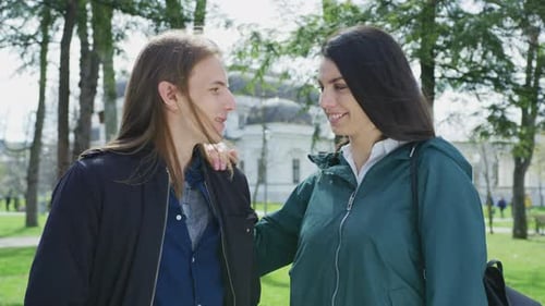 Two Smiling Friends Posing Together in Sunny Park