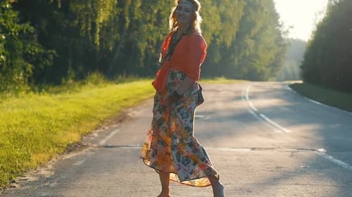 Woman Dances Barefoot in Floral Dress on Country Road