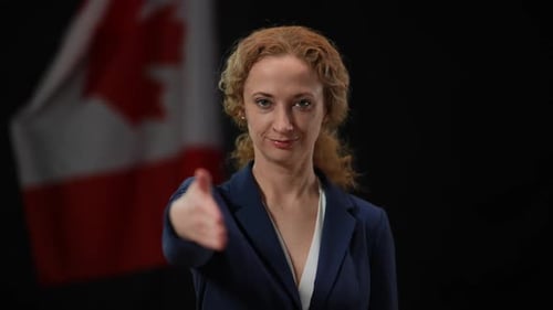 Smiling Woman Offers Handshake With Canadian Flag