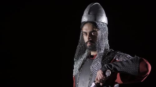 Medieval Knight with Sword and Chainmail in Darkness