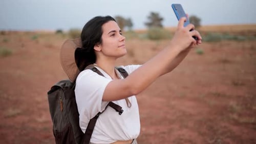 Woman taking selfie in desert