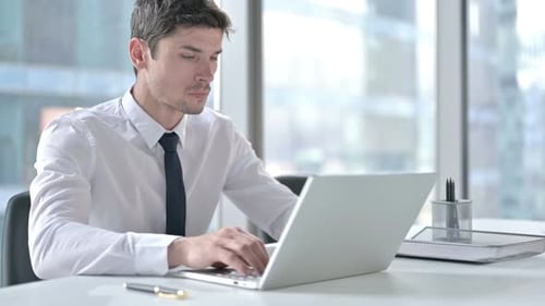 Man Working in Office Experiences Neck Pain