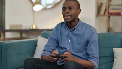 Young Adult Playing Video Game on Couch