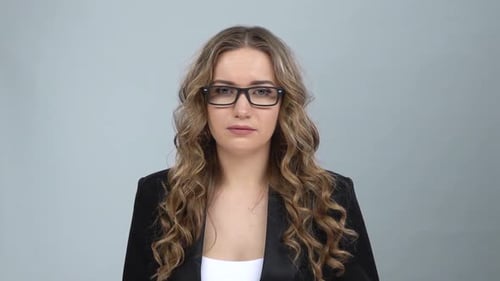 Woman Adjusting Glasses in Studio, Rubbing Neck