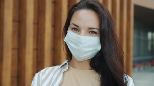 Closeup Portrait of Attractive Girl Wearing Facial Mask Standing Outside in City