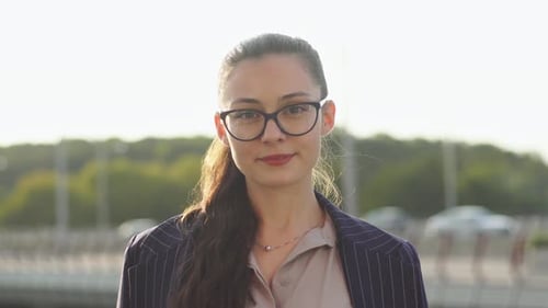 Confident Woman in Blazer Standing Outside